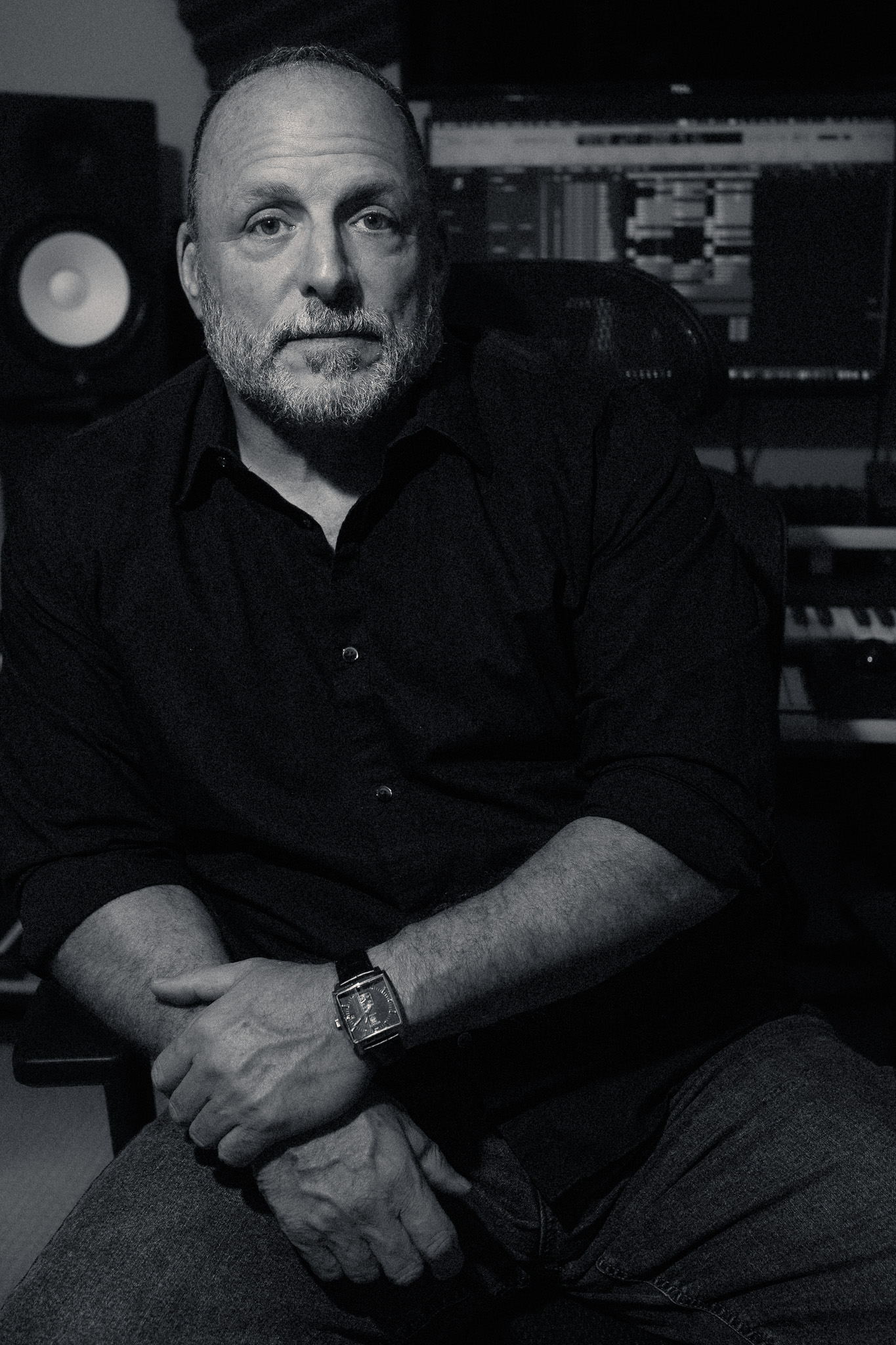 Black-and-white portrait of Peter Amato seated in his recording studio, photographed by his son